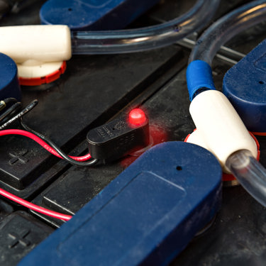 blinky electrolyte indicator attached to industrial battery
