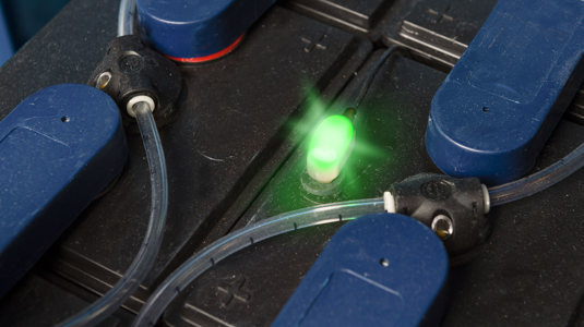 A basicblinky battery electrolyte system on batteries showing green light