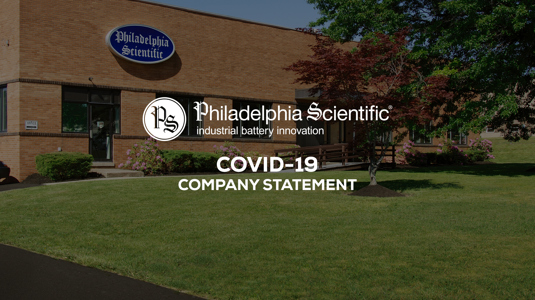 Philadelphia Scientific brown building with garden and trees in front of it with tect infornt of it with covid statement