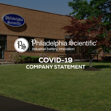 Philadelphia Scientific brown building with garden and trees in front of it with tect infornt of it with covid statement