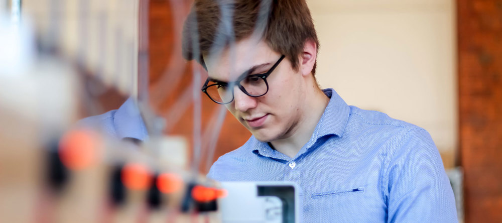 A man creating innovative battery technology in the Philadelphia Scientific warehouse